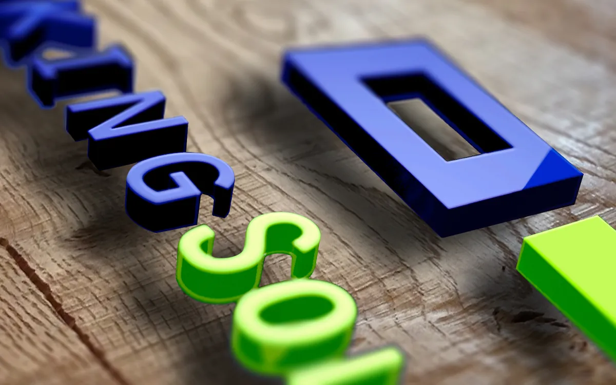3D render of the old logo in glossy blue and green letters on wood